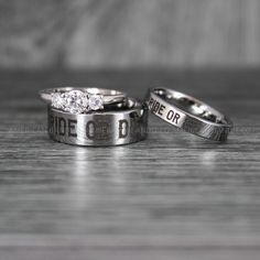 two wedding rings with the words bride and groom engraved on them, sitting next to each other