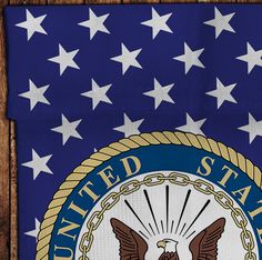 the united states seal with stars and chains on it is hanging from a wooden frame