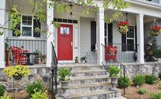 a red door sits on the front steps of a white house