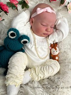 a baby is laying next to two stuffed animals