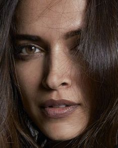 a close up of a woman's face with long hair