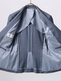 a blue jacket hanging on a clothes hanger