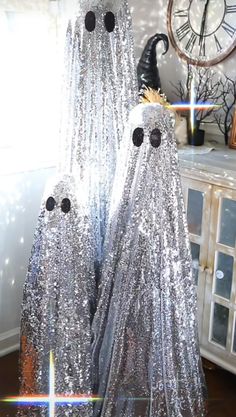 two silver ghost statues sitting on top of a table