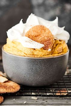 a bowl filled with food sitting on top of a metal rack next to crackers