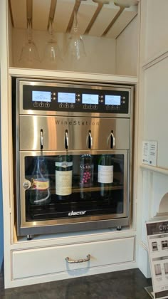 an oven with wine bottles and glasses in it