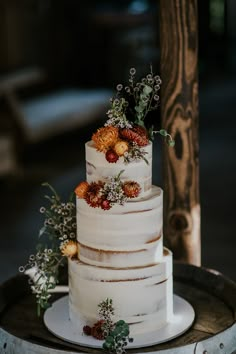 a white wedding cake with flowers on top