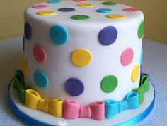 a white cake with multicolored polka dots on it