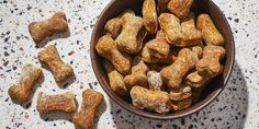 a bowl full of dog treats sitting on a table