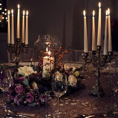 a table topped with lots of candles and flowers