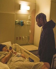 a man standing next to a woman in a hospital bed