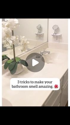 a bathroom sink with a flower in it and the text 3 tricks to make your bathroom smell amazing