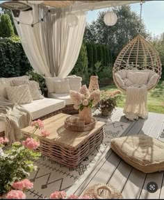 an outdoor living area with wicker furniture and flowers