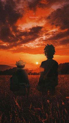 two people standing in the middle of a field at sunset with clouds and sun setting behind them