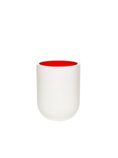 a white and red cup sitting on top of a table