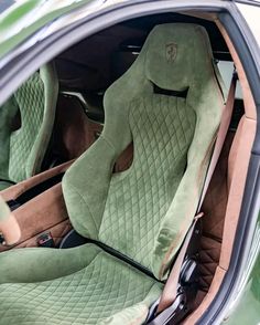 the interior of a car with green leather seats and matching floor mats is shown in this image