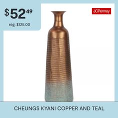 a copper vase sitting on top of a table next to a blue and white background