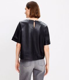 It's luxe, it's cool, it's forever flattering - this faux leather top is one you'll want to perfect every outfit with. Round neck. Short sleeves. Back button keyhole.,Bullet1:20 3/4" long,Imported:Imported,Fit:Fit: Classic — follows your contours with a little room,Length:Length: Abbreviated - hits at natural waist,Fabrication:Imitation Leather Coating : Polyurethane Back : 100% Polyester,Garment Care:Machine Washable Loft Petite Faux Leather Top Size Large Black Women's by Loft Size Petite - L Elegant Leather Tops For Work, Modern Leather Tops For Workwear, Sleek Leather Tops For Workwear, Sleek Leather Tops For Work, Chic Leather Tops For Fall, Elegant Leather Tops For Fall, Elegant Leather Tops For Night Out, Faux Leather Tops For Workwear In Fall, Trendy Leather Tops For Spring