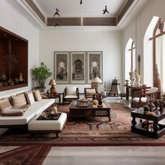 a living room filled with lots of furniture next to tall windows on either side of the wall