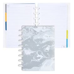 an open spiral bound notebook with marbled paper