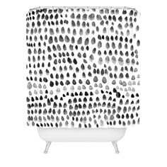 a shower curtain with black and white spots on it's side, against a white background