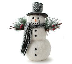 a snowman wearing a hat and scarf with pine needles on it's head