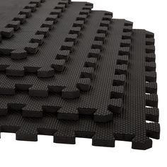 black rubber flooring tiles on white background with clippings for use in indoor play areas