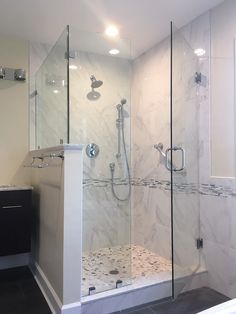 a walk in shower sitting next to a sink and a bathtub with glass doors