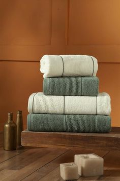 a stack of towels sitting on top of a wooden table