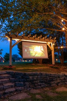 an outdoor movie screen in the evening