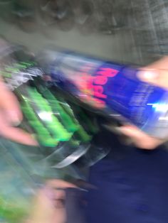 blurry photograph of people holding soda cans