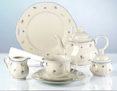 a white tea set with blue trimmings and stars on the rim is shown