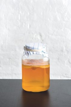 a jar filled with liquid sitting on top of a table