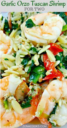 the shrimp and vegetable dish is ready to be eaten on the plate, with text overlay that reads garlic orzo tuscan shrimp stir - fry