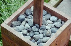 a wooden box filled with lots of rocks