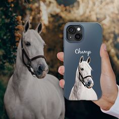 a person holding up a phone case with a photo of a horse and the words champ on it