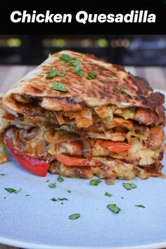 chicken quesadilla stacked on top of each other with peppers and onions in the middle