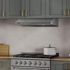 a stove top oven sitting inside of a kitchen next to wooden counter tops and cabinets