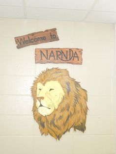 a sign that says welcome to narnda with a lion's head painted on it