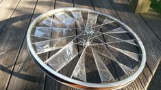 a wheel that is sitting on top of a wooden table with no wheels or spokes