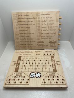 a wooden board game with two dices on the front and one in the back