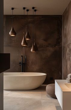 a large white bath tub sitting in a bathroom next to a sink and mirror with lights hanging from the ceiling