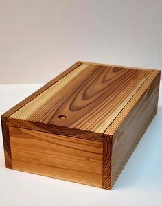 a wooden box sitting on top of a white table