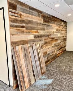 an empty room with wood panels on the wall