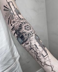 a man's arm with an abstract tattoo design on the left side of his arm