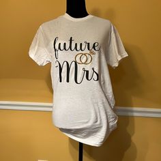 Price Is Firmrecently Reduced So You Say You Want To Get Married? Ring In Your Pending Status Update From Miss To Mrs Wearing Our Future Mrs Tee!!! Purchase This Tee By Faith Or Perhaps You’re Already Engaged, Purchase This Tee To Show Your Updated Status. Future Mrs Embroidered Tee Brand New Pet-Free Smoke-Free Only 1 Left Reg Price $35 Married Ring, Status Update, Miss To Mrs, From Miss To Mrs, Future Mrs, Embroidered Tee, Our Future, Only 1, Say You