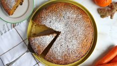 a cake on a plate next to some carrots