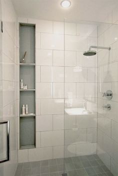 a walk in shower sitting inside of a bathroom