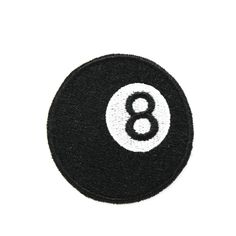 a black and white eight ball patch with the number 8 in it's center