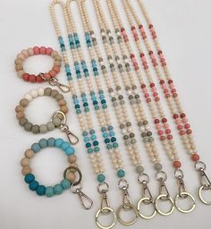 several necklaces and bracelets are laid out on a white surface with metal clasps