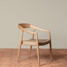 a wooden chair sitting on top of a brick floor